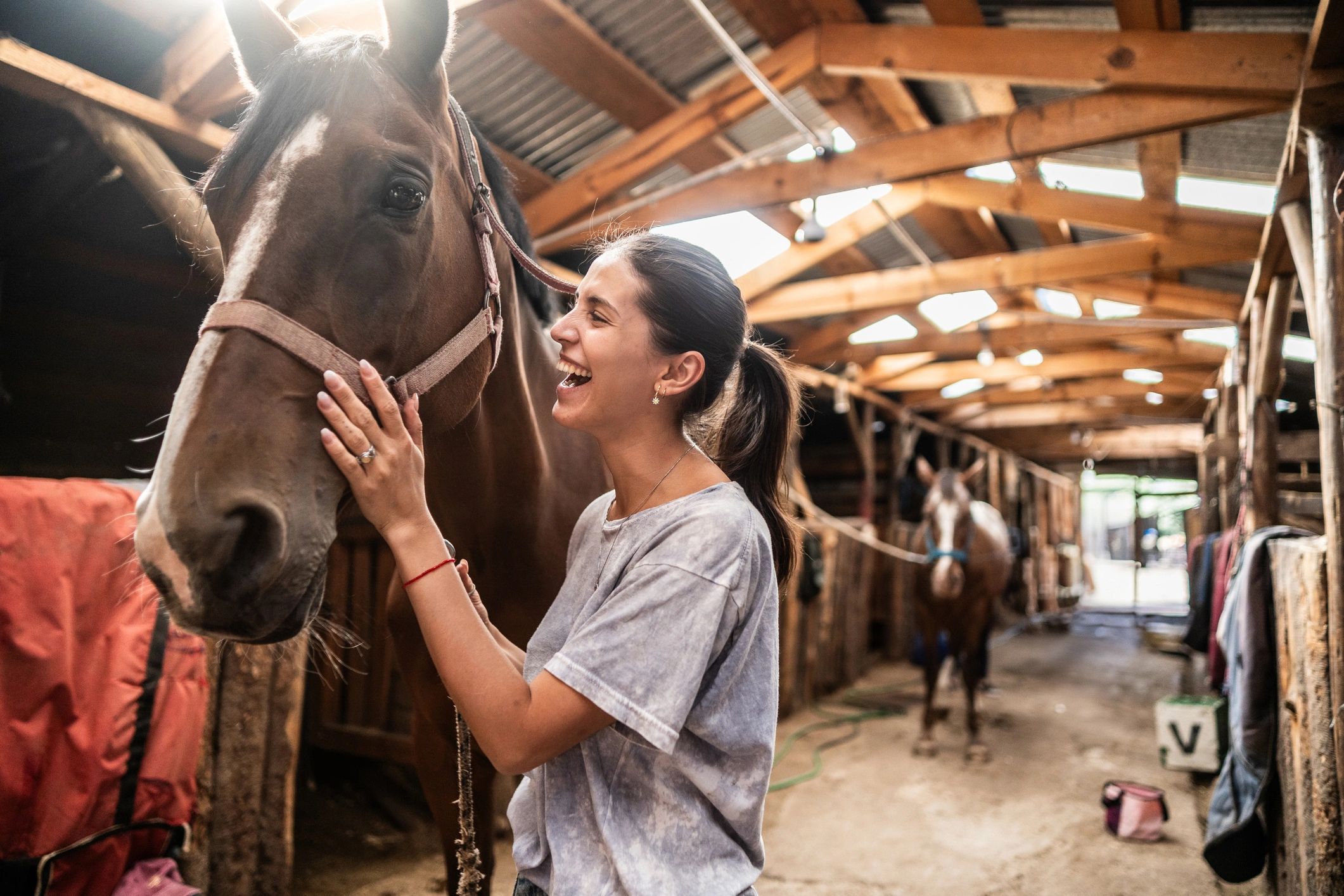 Trainer bonding with a horse at the stable