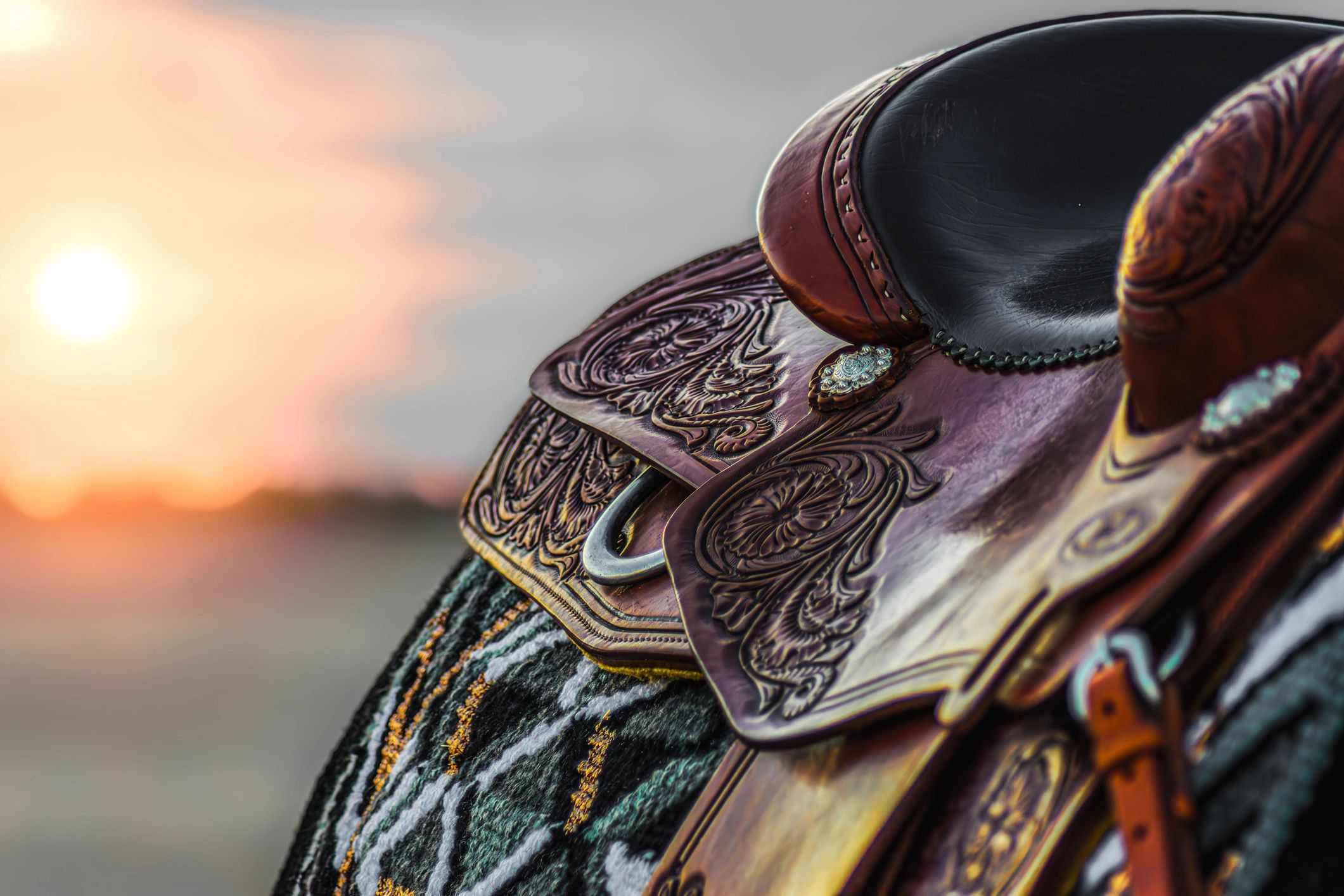 Western saddle at sunset