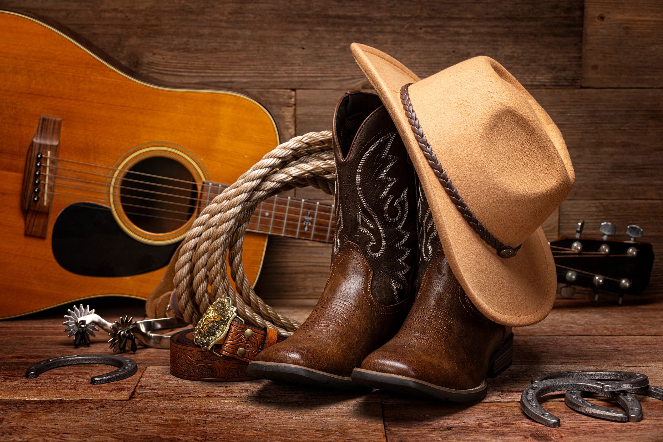 Western still life with cowboy boots and hat