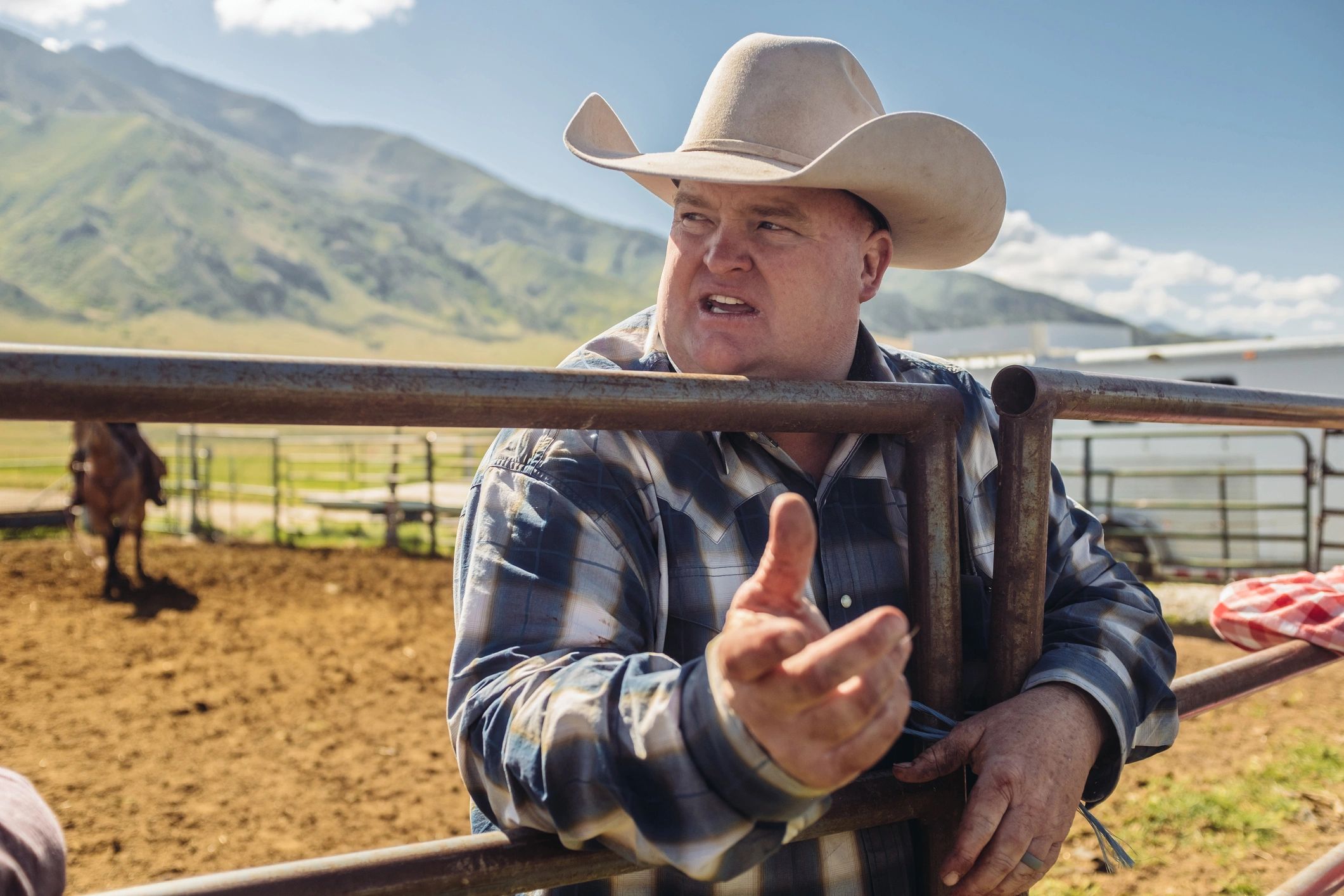 Cowboy preparing for ranch work in a cattle corral