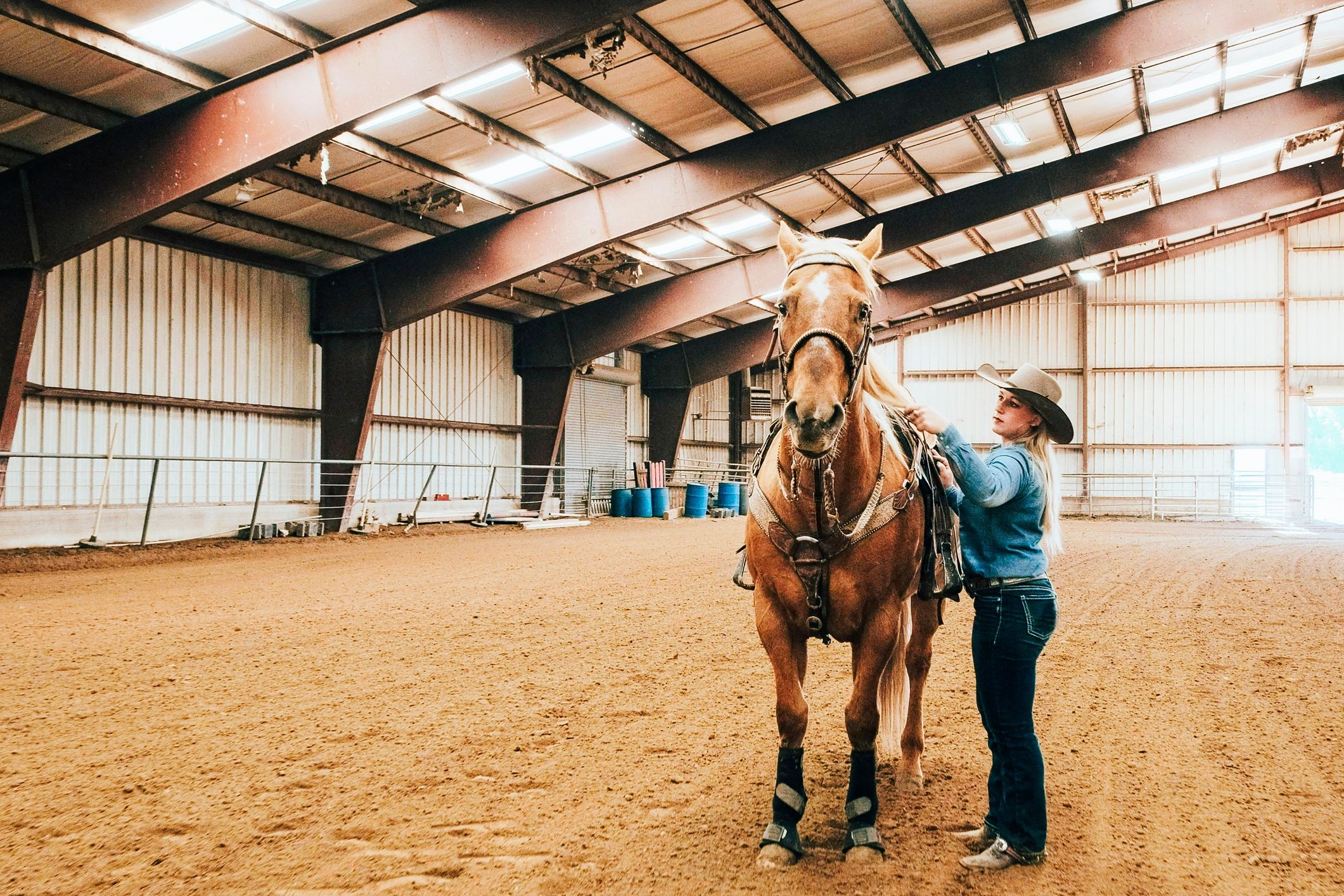Cowgirl practicing horsemanship in an indoor arena
